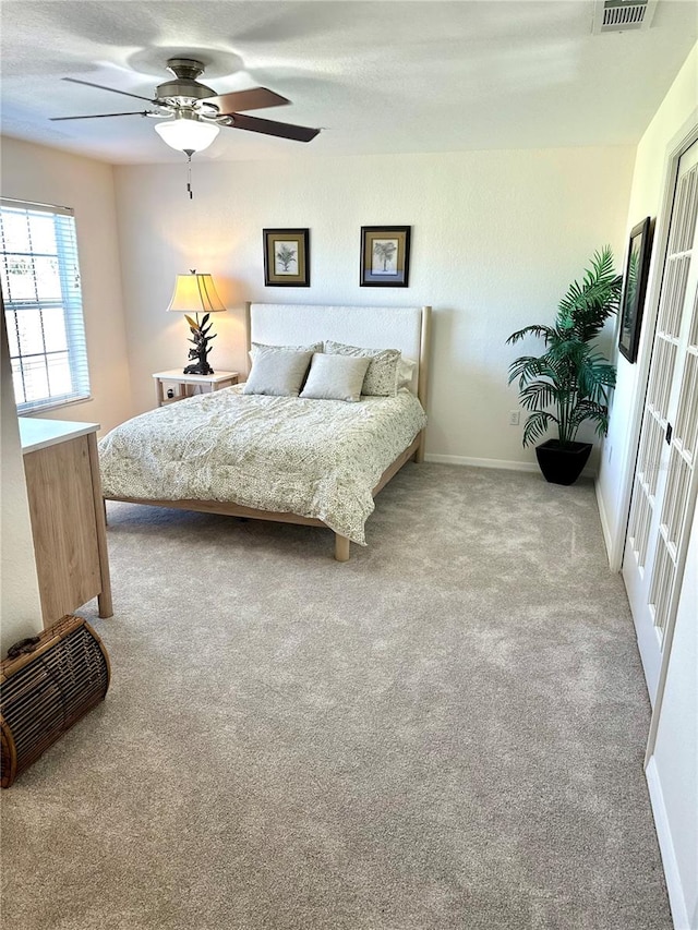 carpeted bedroom with ceiling fan