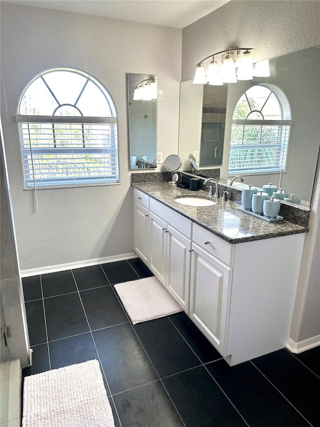 bathroom featuring tile patterned flooring and vanity