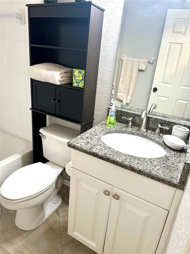 bathroom featuring tile patterned flooring, vanity, and toilet