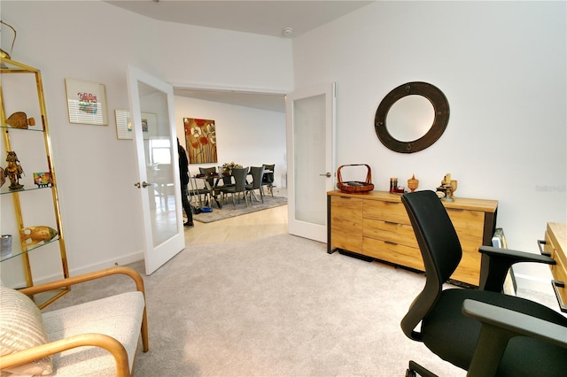 carpeted office space featuring french doors