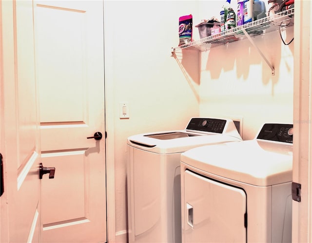 clothes washing area featuring independent washer and dryer