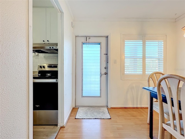 doorway featuring light hardwood / wood-style flooring and crown molding