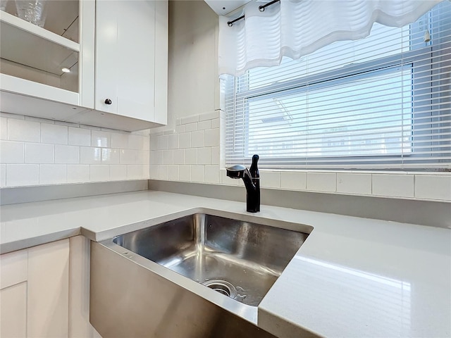 interior details featuring tasteful backsplash and sink