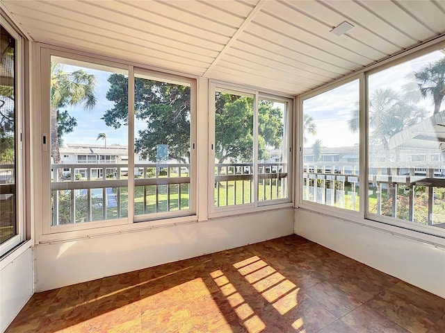 unfurnished sunroom with plenty of natural light