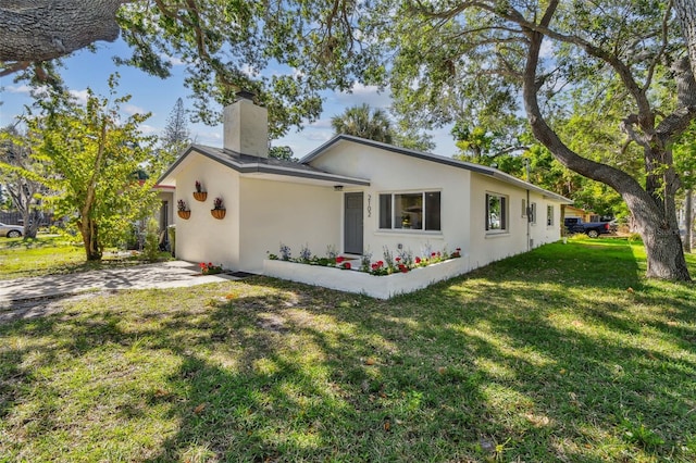 view of side of home with a yard