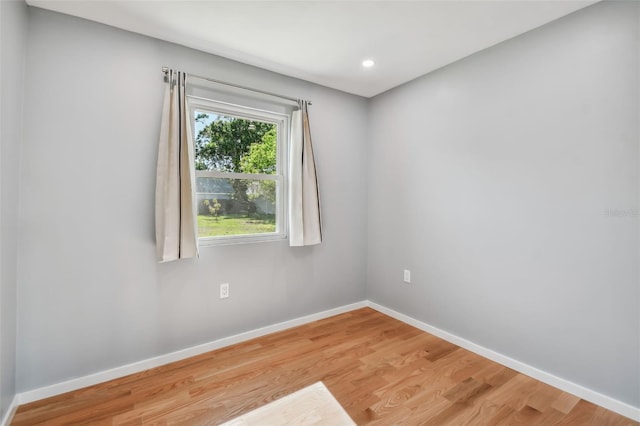 unfurnished room with wood-type flooring