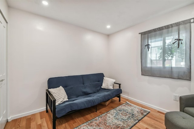 living area with hardwood / wood-style flooring