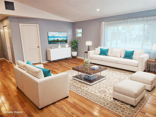 living room featuring wood-type flooring and vaulted ceiling