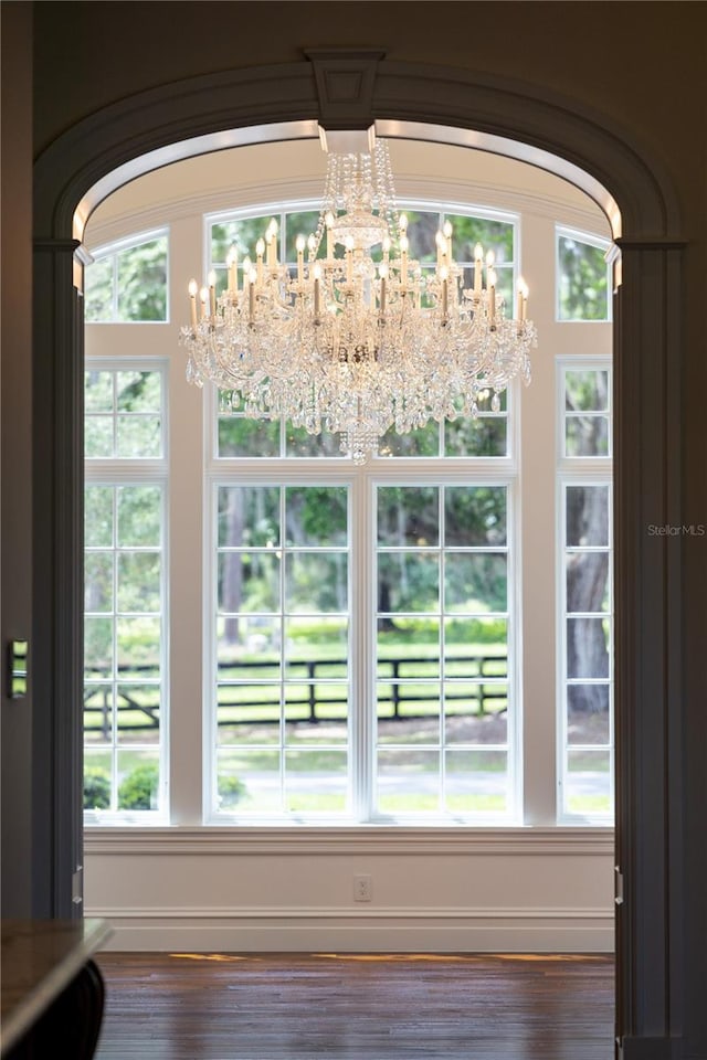 doorway with a chandelier and hardwood / wood-style flooring