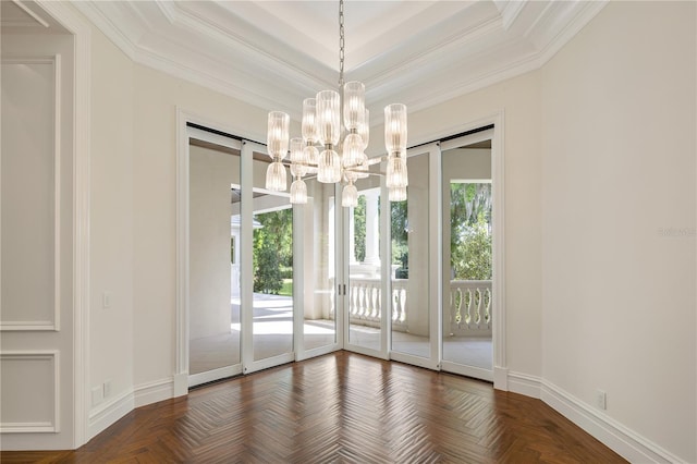 interior space featuring ornamental molding, a notable chandelier, parquet floors, and a tray ceiling