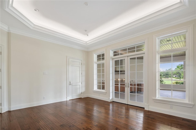 spare room with french doors, ornamental molding, dark hardwood / wood-style floors, and a raised ceiling