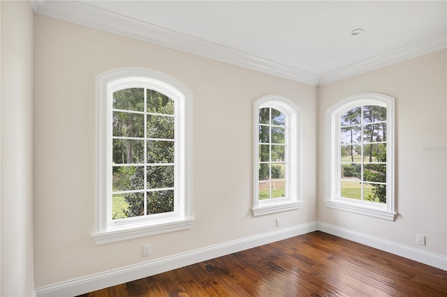 empty room with ornamental molding and dark hardwood / wood-style flooring