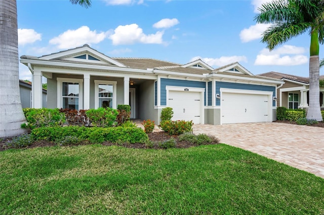 view of front of house featuring a front yard and a garage