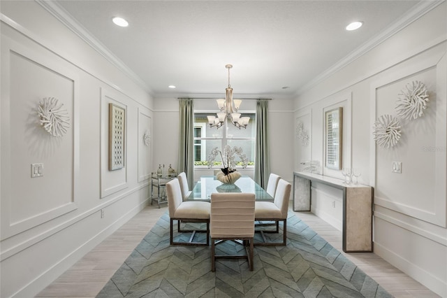 dining space with ornamental molding, a chandelier, and light wood-type flooring