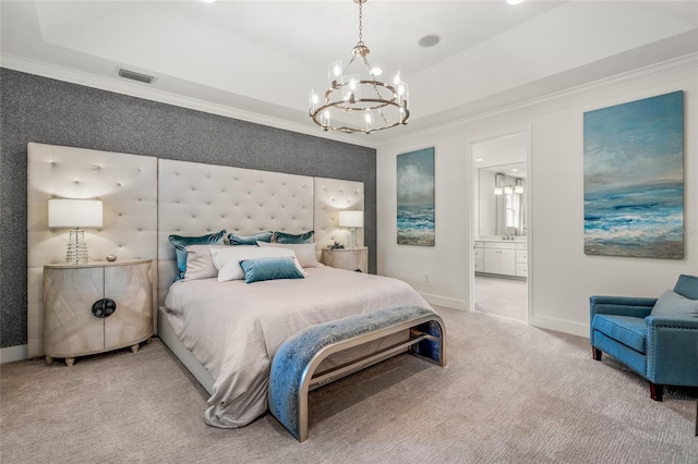 bedroom featuring a raised ceiling, a notable chandelier, light carpet, and connected bathroom