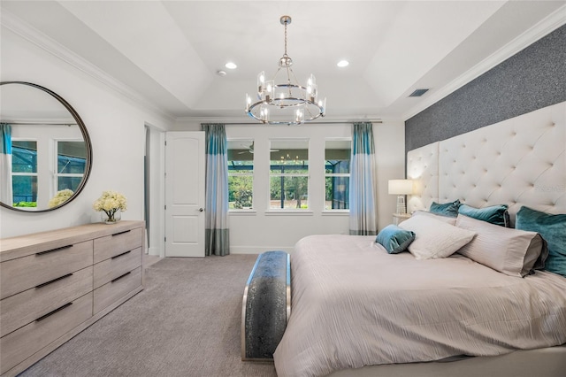 bedroom with carpet floors, a notable chandelier, a tray ceiling, and ornamental molding