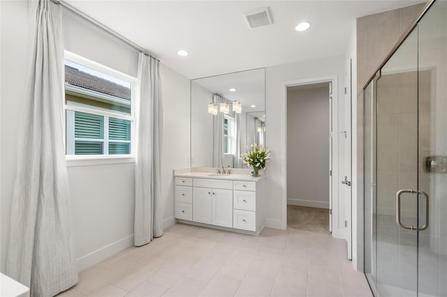 bathroom featuring large vanity, an enclosed shower, and tile floors