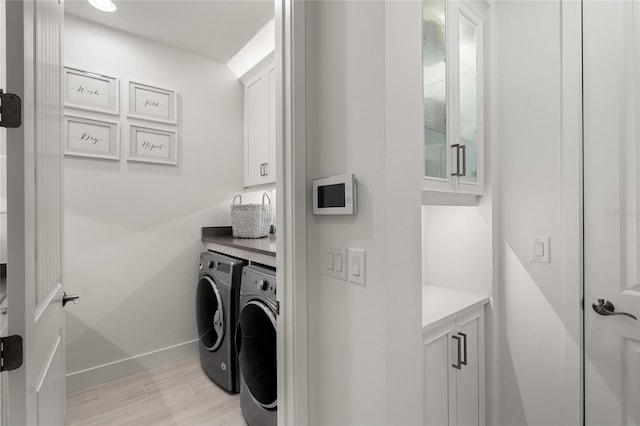 laundry area featuring cabinets and washing machine and clothes dryer