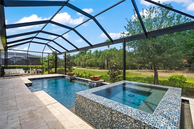 view of pool featuring an in ground hot tub, a lanai, and a patio