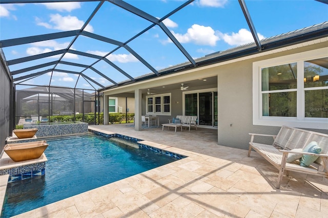 view of pool featuring a patio area, ceiling fan, and a lanai