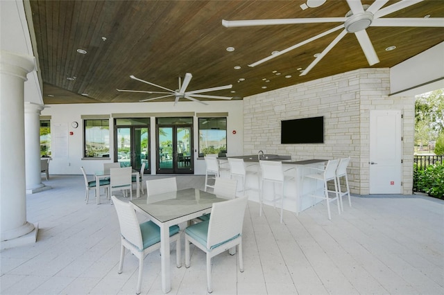 view of terrace featuring an outdoor bar and ceiling fan