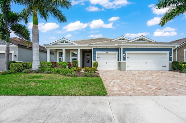 view of front of house featuring a garage and a front lawn