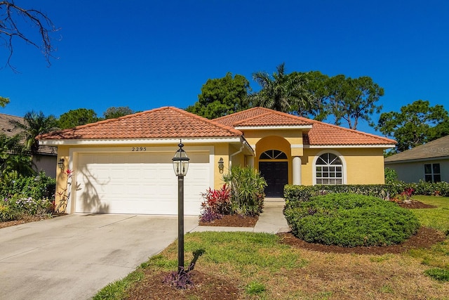 mediterranean / spanish-style house with a garage