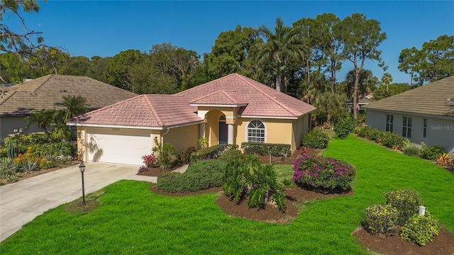 mediterranean / spanish-style home with a garage and a front yard