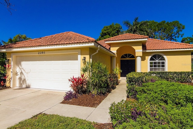 mediterranean / spanish-style home featuring a garage