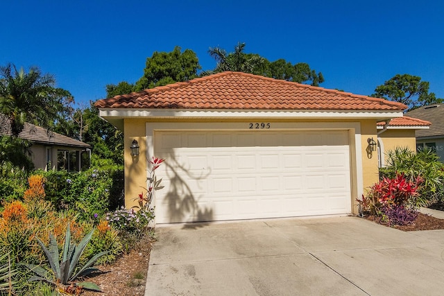 mediterranean / spanish house with a garage