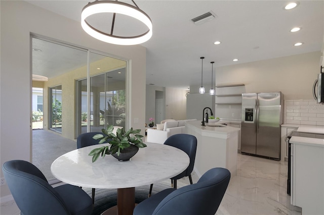 tiled dining area featuring sink