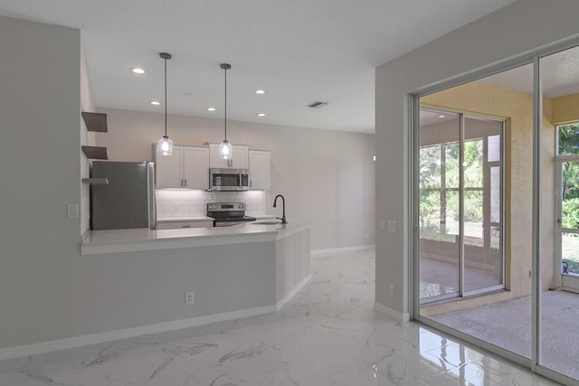 kitchen featuring appliances with stainless steel finishes, light tile floors, tasteful backsplash, white cabinetry, and pendant lighting