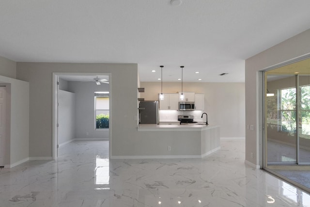 interior space featuring plenty of natural light, appliances with stainless steel finishes, white cabinetry, and light tile flooring