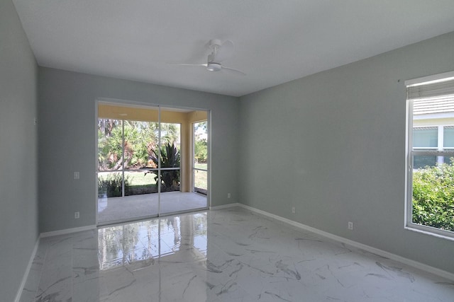 unfurnished room with ceiling fan and tile floors