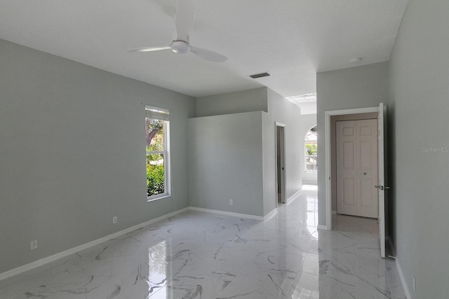 empty room featuring ceiling fan and light tile floors