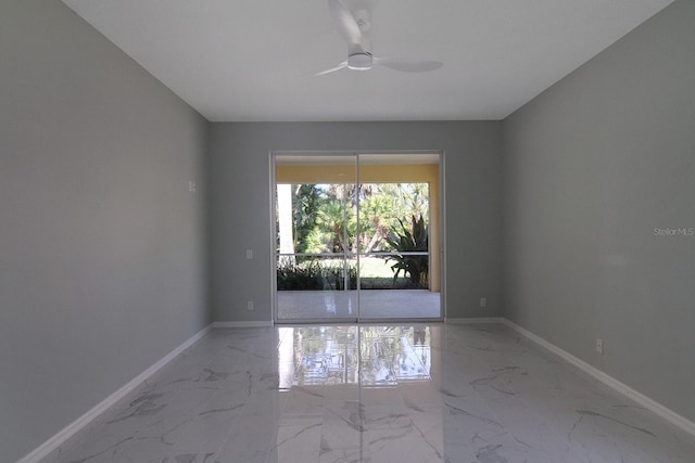 spare room with tile flooring and ceiling fan