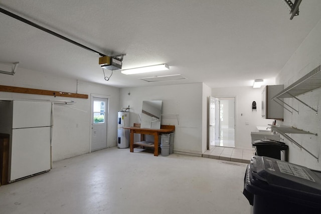 garage with water heater and a garage door opener