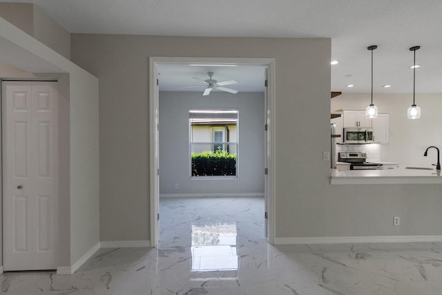 corridor with sink and light tile floors