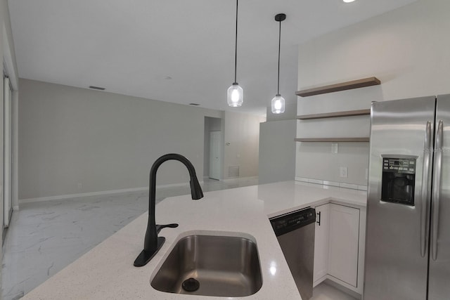 kitchen featuring hanging light fixtures, light tile flooring, white cabinetry, appliances with stainless steel finishes, and sink