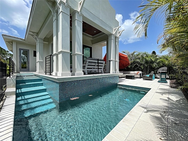 view of pool with a grill, an outdoor hangout area, and a patio