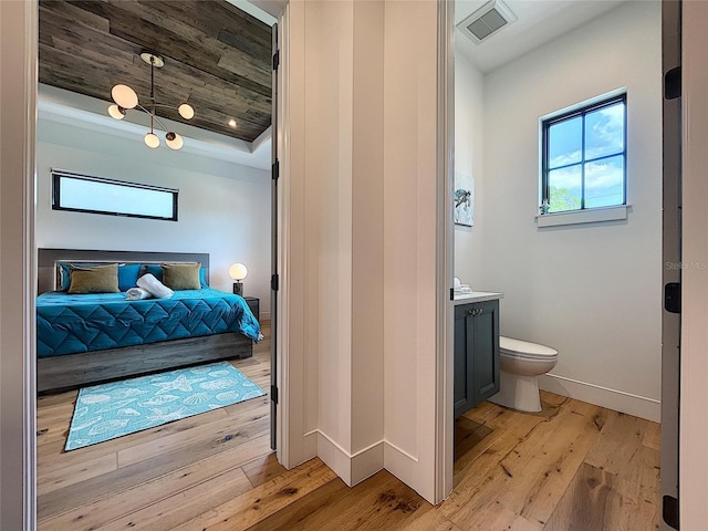 bathroom featuring wood ceiling, vanity, a raised ceiling, and hardwood / wood-style flooring