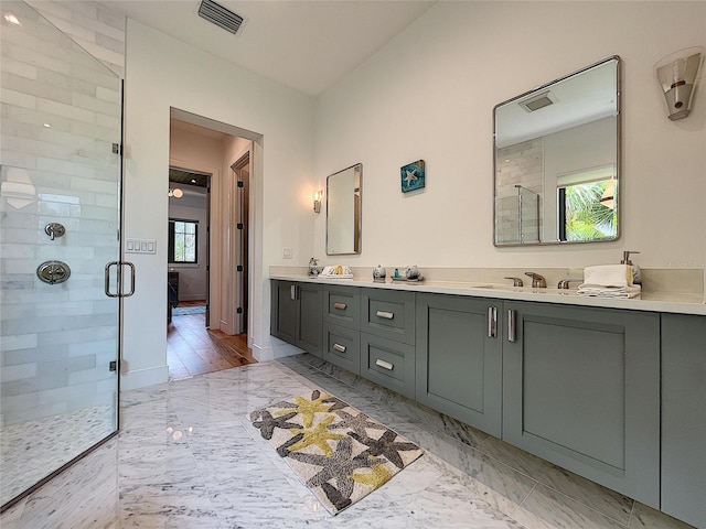 bathroom with an enclosed shower, hardwood / wood-style flooring, and dual vanity