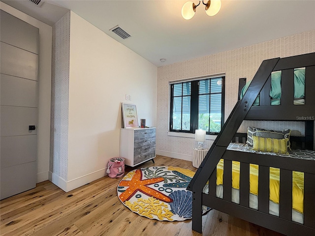 bedroom with hardwood / wood-style flooring