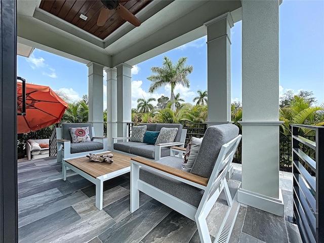 wooden terrace with outdoor lounge area and ceiling fan