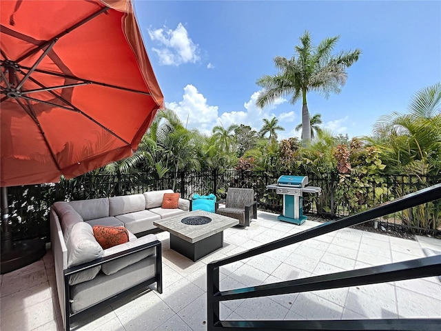 view of patio with a balcony, an outdoor living space with a fire pit, and a grill