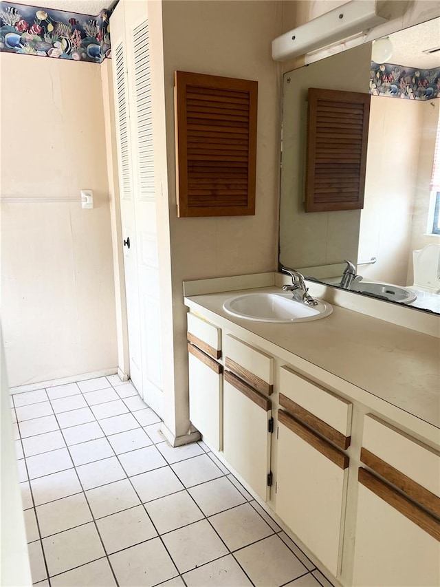 bathroom with tile flooring and vanity