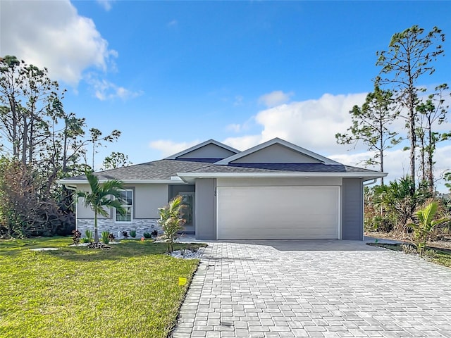 view of front of property with a front yard and a garage