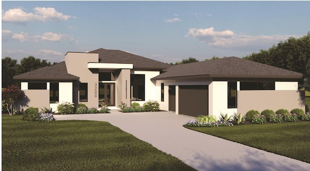 prairie-style house featuring a garage and a front lawn