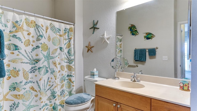 bathroom featuring vanity, toilet, and walk in shower