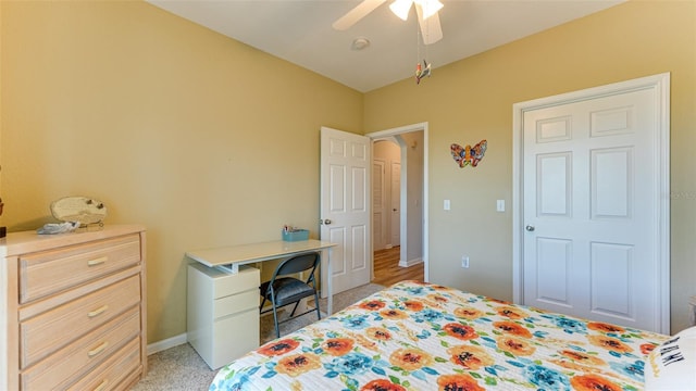 bedroom featuring ceiling fan and light colored carpet